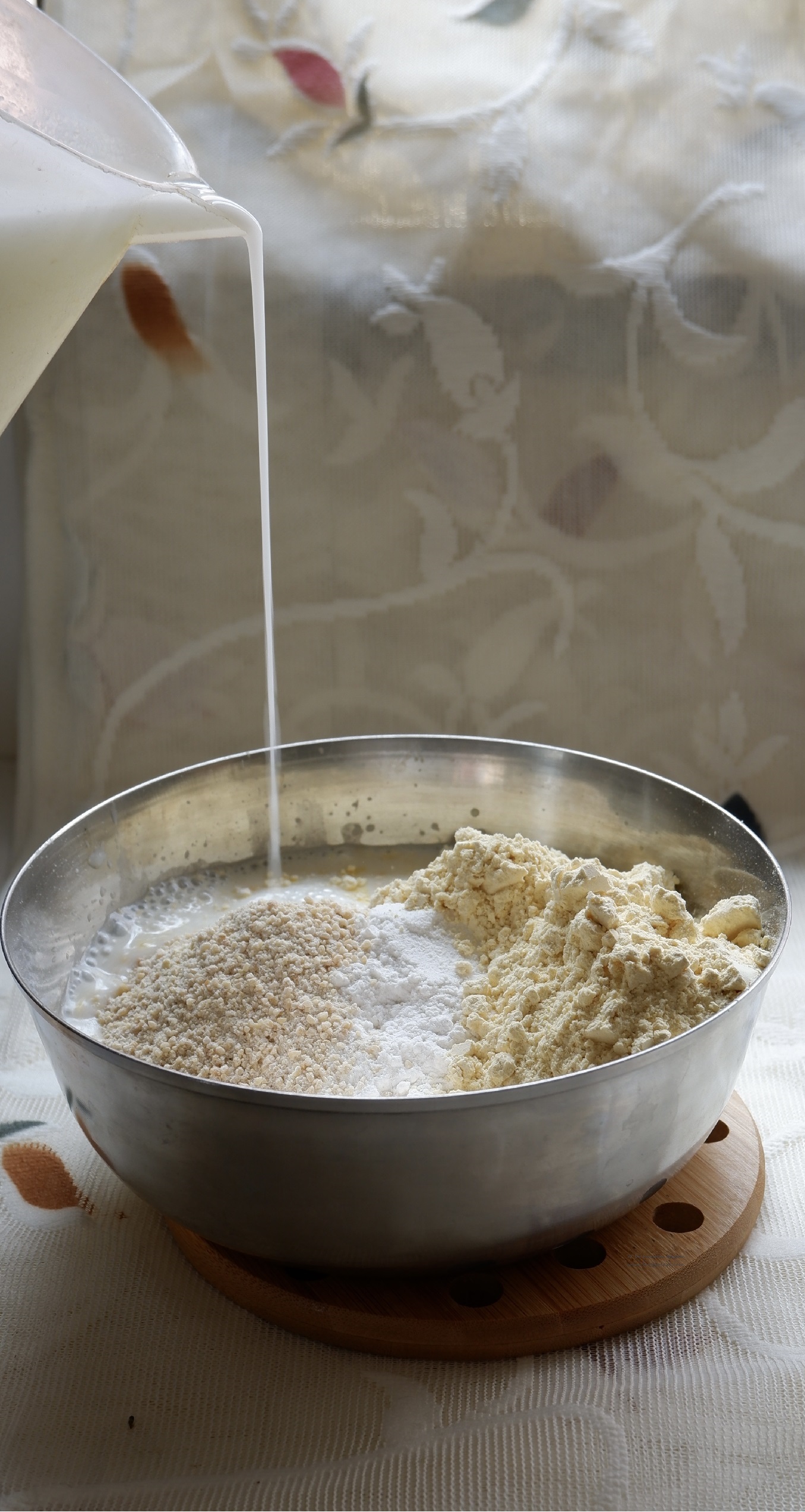 Buttermilk pouring over flour